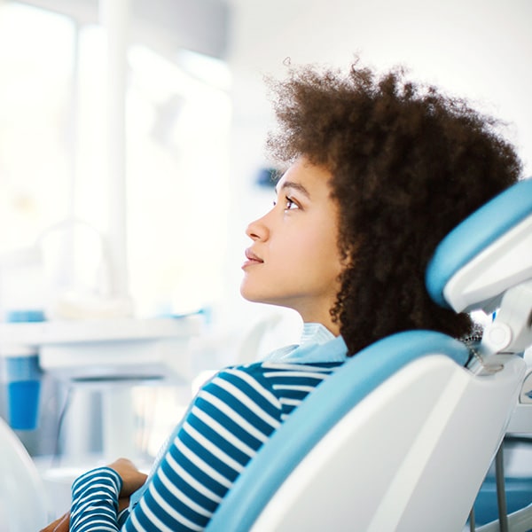 A woman in the dentist's chair waiting for her dental treatment