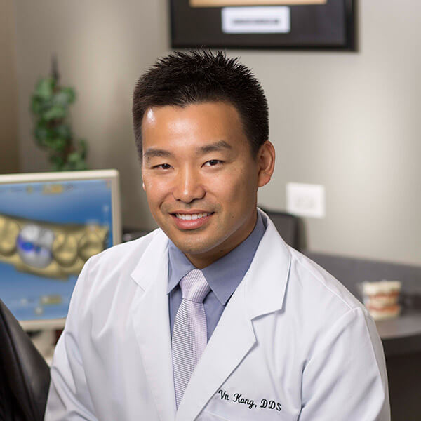 Dr. Kong in his office wearing his white coat.