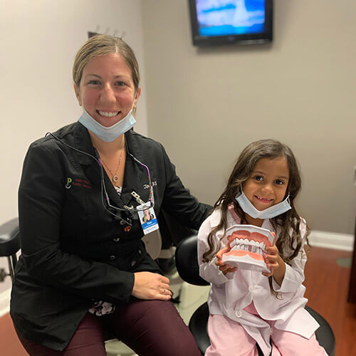 Westgate Family Dental staff and a young girl sitting in the dentist office