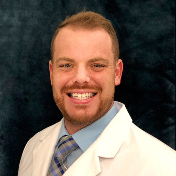 Dr. Christopher DeMarco, in white coat