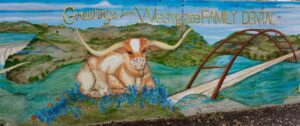 A mural with Bevo the longhorn next to the 360 bridge in South Austin with Greetings from Westgate Family Dental