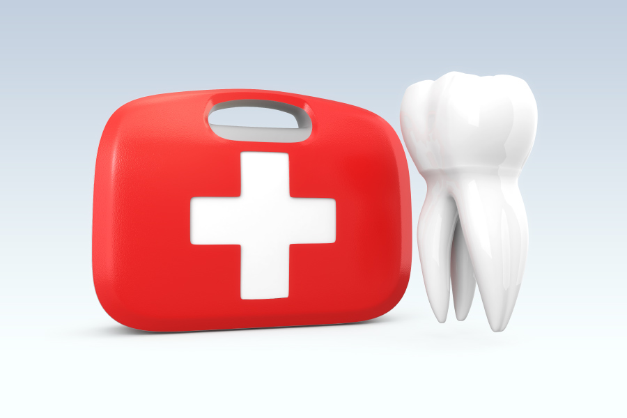 A white tooth floats next to a red and white first aid kit for a dental emergency
