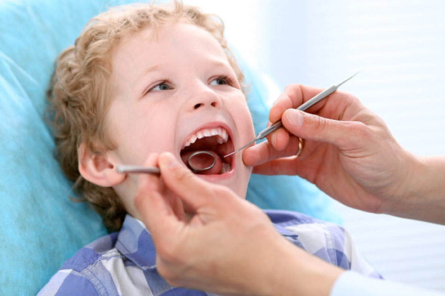 young boy getting a regular dental exam